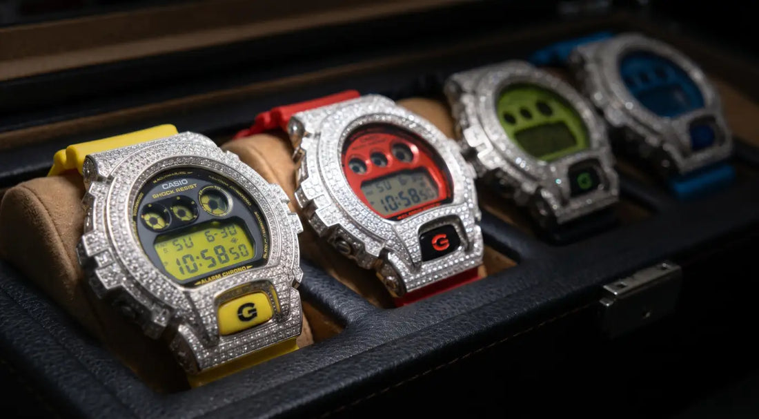 Collection of iced-out custom G-Shock DW6900 watches with GRA certified VVS1 diamond stones displayed in a personal watch box, Retaliate colourway guide