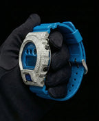 Retaliate iced out gshock mod with vvs1 diamonds in blue with a blue band, up close, side view.