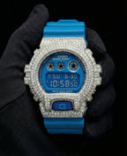 Retaliate iced out gshock mod with diamonds in blue with a blue band, up close, front view.