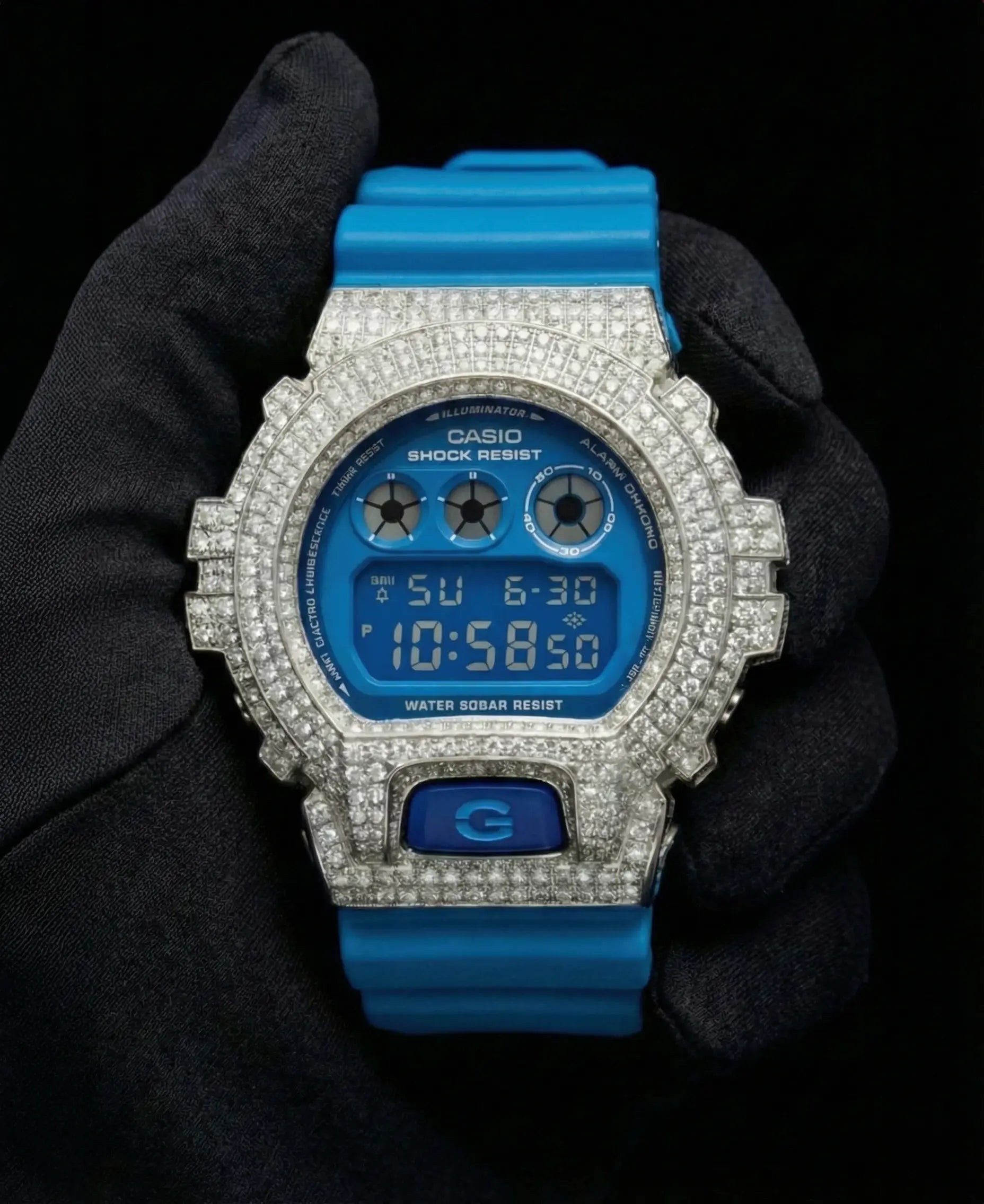 Retaliate iced out gshock mod with diamonds in blue with a blue band, up close, front view.