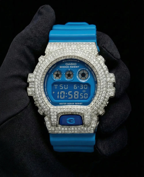 Retaliate iced out gshock mod with diamonds in blue with a blue band, up close, front view.