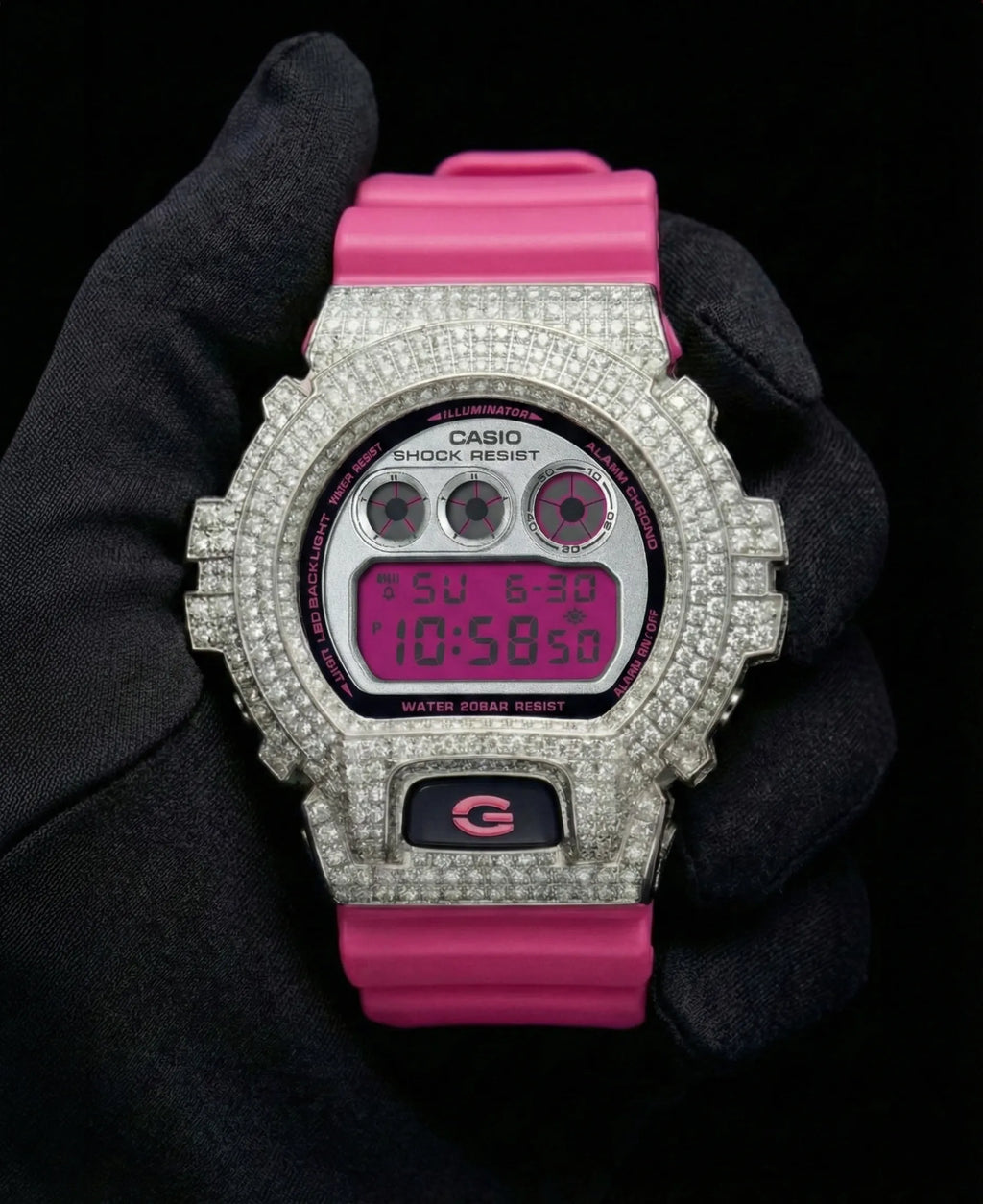 Retaliate iced out gshock diamond mod with vvs1 stones in pink and silver with pink band, front view.