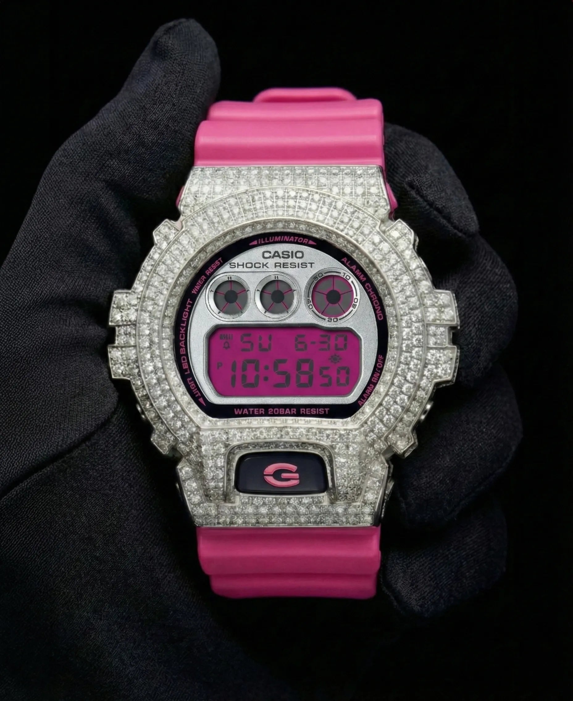 Retaliate iced out gshock diamond mod with vvs1 stones in pink and silver with pink band, front view.