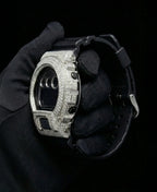 Retaliate iced out gshock mod with vvs1 diamonds in black and silver with black band, side view.