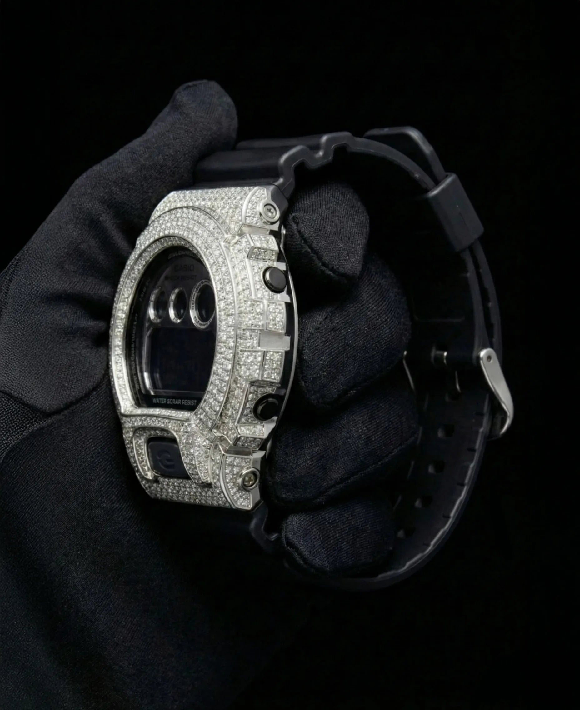 Retaliate iced out gshock mod with vvs1 diamonds in black and silver with black band, side view.