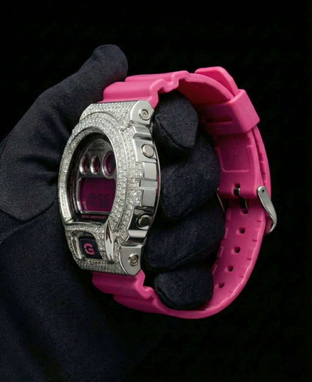 Retaliate iced out gshock diamond mod with vvs1 stones in pink and silver with pink band, side view.